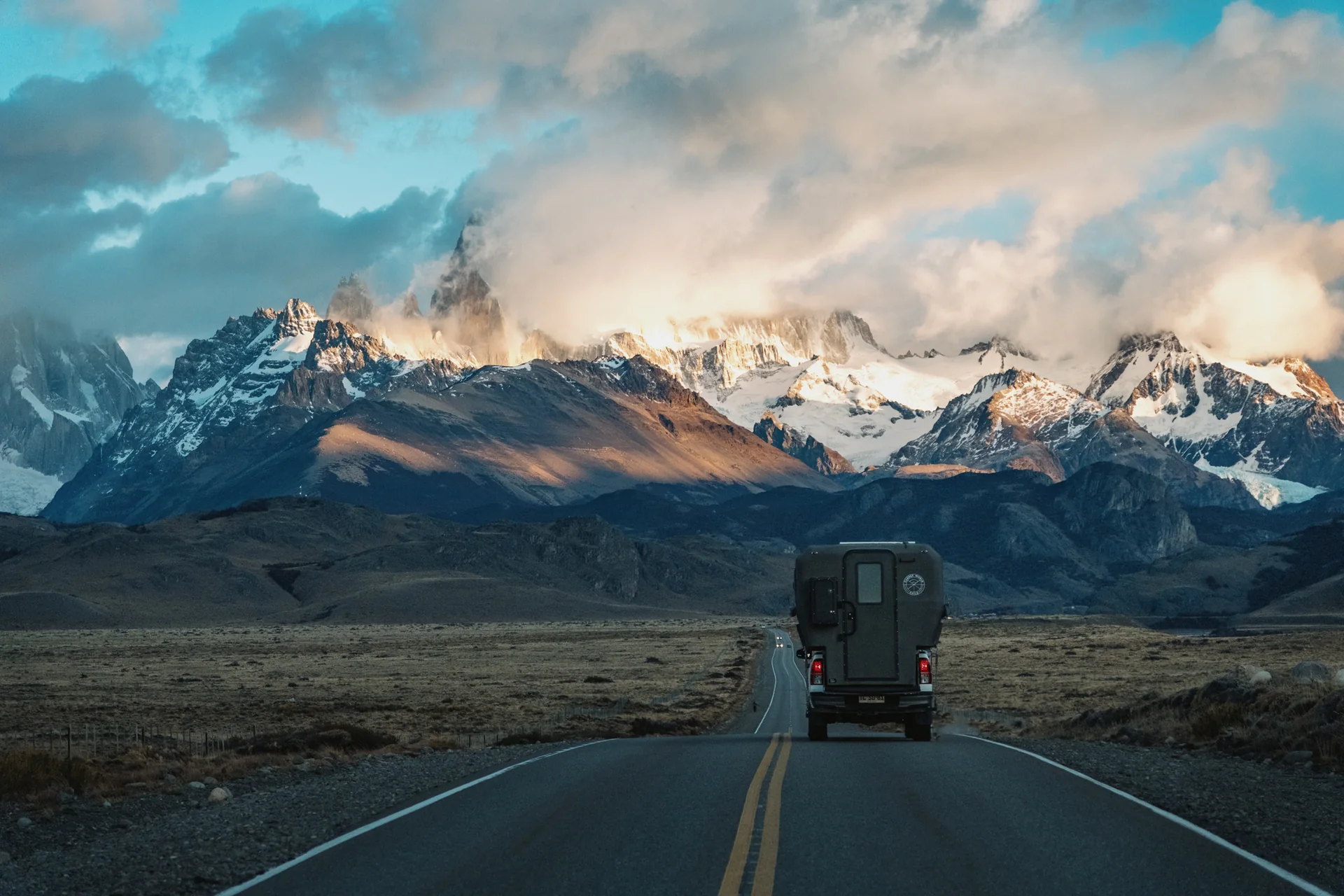 Camper on the road towards the mountains