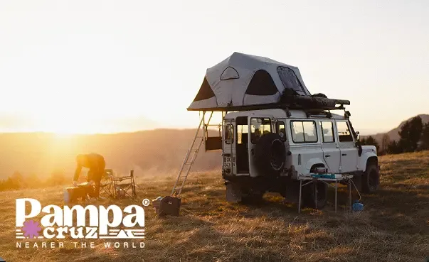 Pickup with a roof top tent at sunset, with the Pampa Cruz logo