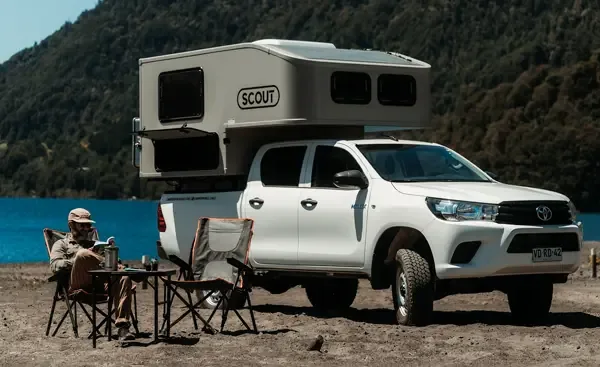 Scout camper on a pickup by the lake