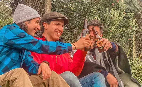 Friends toasting with beer outdoors