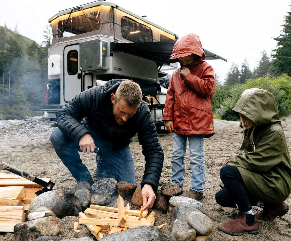 Family by a campfire with the Yoho Pop-Up open behind them